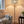 Stehlampe aus gebürstetem Edelstahl mit rundem Lampenschirm aus Metall im modernen Design